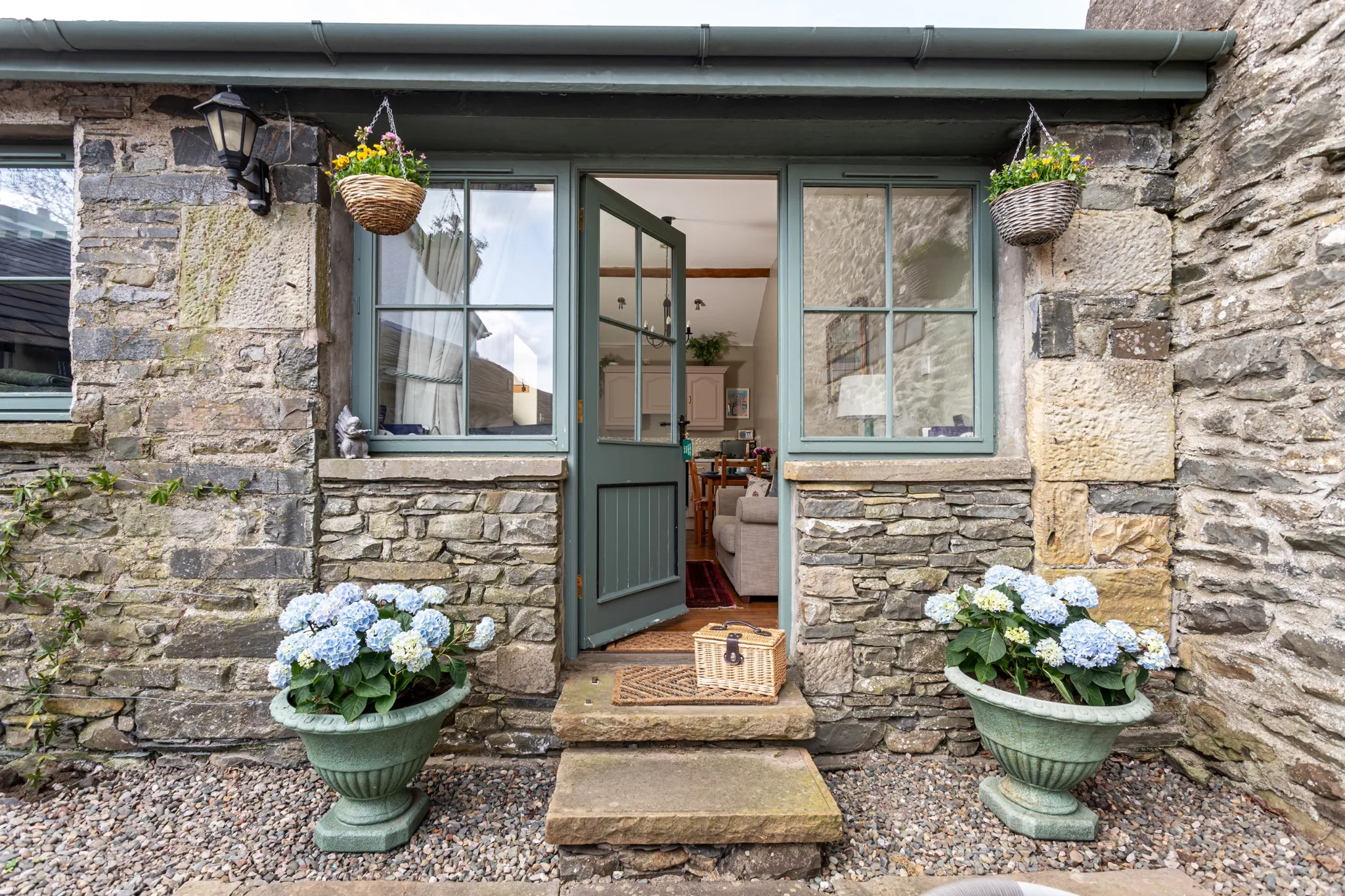 Stone cottage entrance with hydrangeas